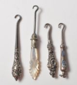 COLLECTION OF FOUR VICTORIAN SILVER BUTTON HOOKS WITH AGATE AND MOTHER OF PEARL HANDLES.