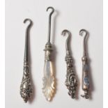COLLECTION OF FOUR VICTORIAN SILVER BUTTON HOOKS WITH AGATE AND MOTHER OF PEARL HANDLES.