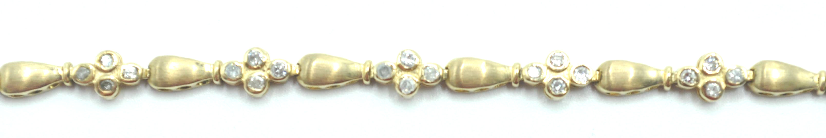 STAMPED 10K GOLD AND DIAMOND BRACELET.