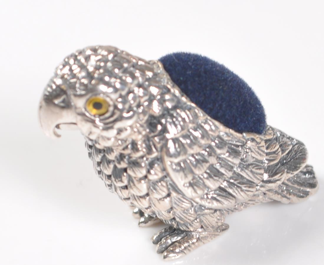 STAMPED STERLING SILVER PARROT PIN CUSHION.