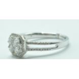 STAMPED 18K WHITE GOLD AND DIAMOND CLUSTER RING.