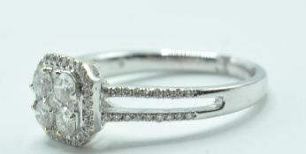 STAMPED 18K WHITE GOLD AND DIAMOND CLUSTER RING.