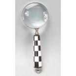 LARGE HANDHELD MAGNIFYING GLASS WITH CHECK HANDLE.