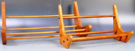 TWO MID CENTURY TEAK AND OAK BOOMERANG BOOK STANDS