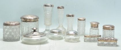 LARGE COLLECTION OF EARLY 20TH CENTURY SILVER LIDDED VANITY DRESSING TABLE ITEMS.