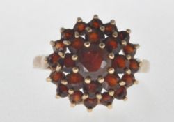 STAMPED 375 9CT GOLD AND RED STONE CLUSTER RING.