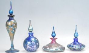 FOUR OKRA STUDIO ART GLASS IRIDESCENT GLASS BOTTLES