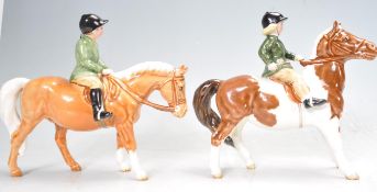 PAIR OF BESWICK HORSE AND RIDER FIGURES INCLUDING NO 1499 AND NO 1500.