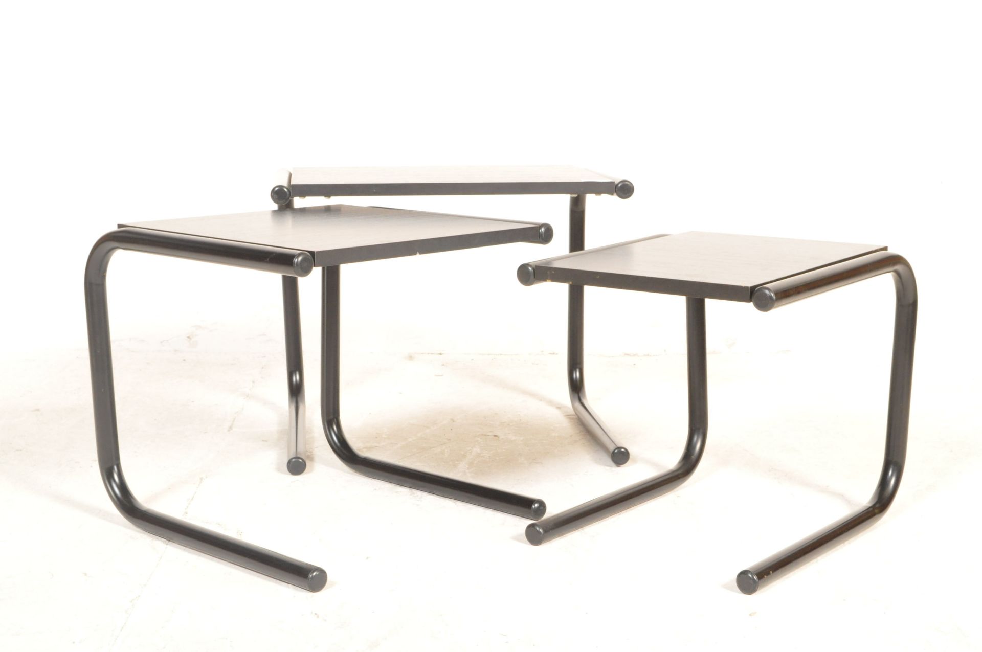 1970'S RETRO NEST OF TABLES RAISED AND SUPPORTED BY TUBULAR LEGS