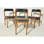 FOUR DANISH INSPIRED TEAK WOOD AND BLACK VINYL DINING CHAIRS