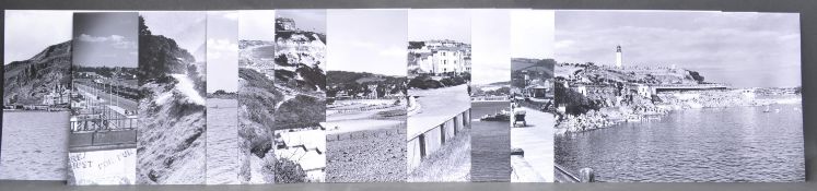 TWELVE BLACK AND WHITE PRINTEDPOSTCARD PHOTOGRAPHS OF SEASIDE TOWNS.