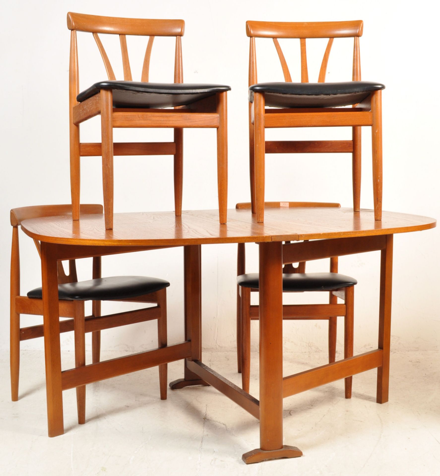 FOUR TEAK WOOD FRAME DANISH INSPIRED DINING CHAIRS AND A DROP LEAF DINING TABLE