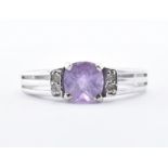 9CT WHITE GOLD AND PURPLE STONE RING