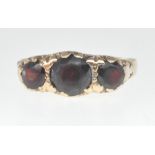 9CT GOLD AND THREE RED STONE RING