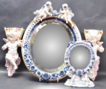 TWO CERAMIC CHERUB MIRRORS & PAIR OF WALL POCKETS