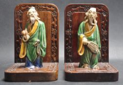 TWO 1930’S CHINESE ORIENTAL HARD WOOD AND CERAMIC FIGURINE BOOKENDS