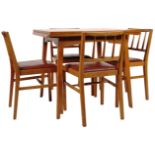 E. GOMME - G-PLAN GOLDEN OAK DINING TABLE AND FOUR CHAIRS