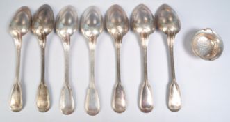 SILVER TEA STRAINER AND SEVEN TABLE SPOONS BY CHRISTOFLE