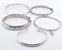 FIVE SILVER BANGLE BRACELETS