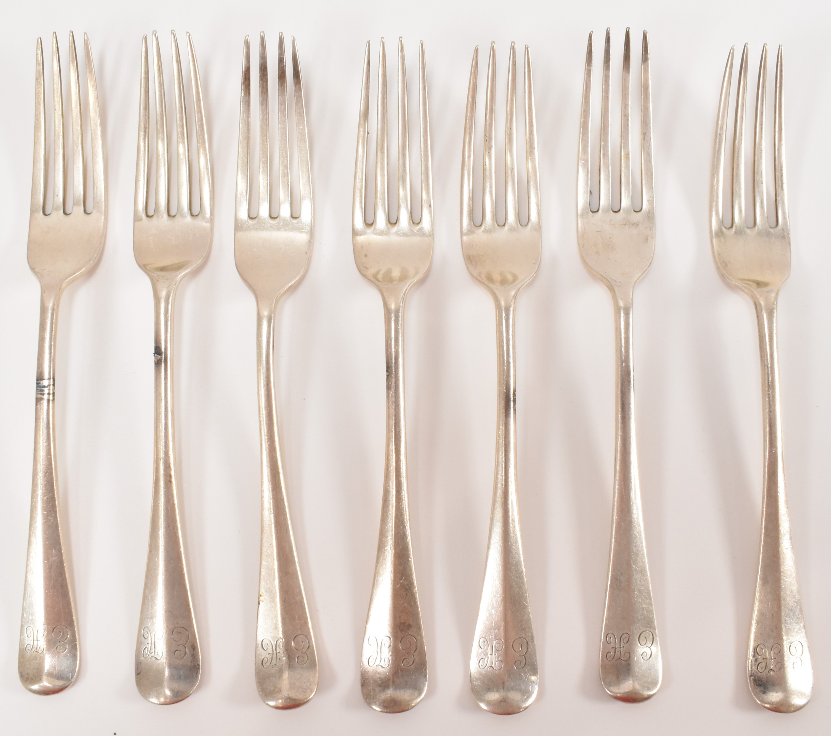 HARLEQUIN SET OF SEVEN SILVER FORKS