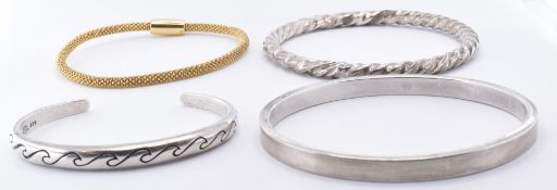 FOUR SILVER BANGLE BRACELETS