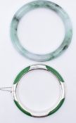TWO JADE BANGLES INCLUDING ONE BEING SILVER BOUND