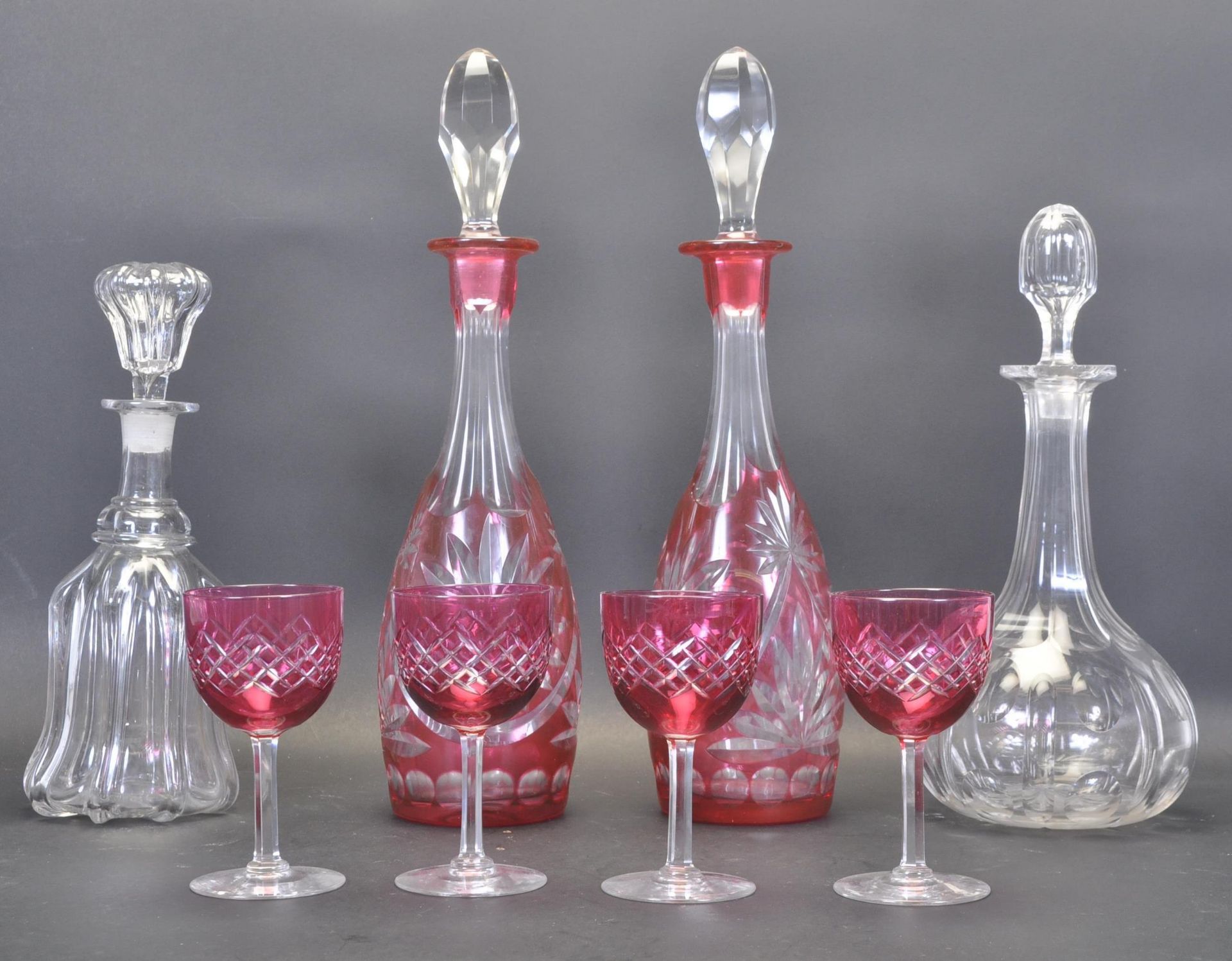 TWO 19TH CENTURY VICTORIAN CRANBERRY GLASS DECANTERS AND SHERRY GLASSES