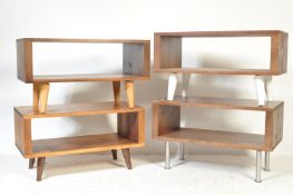 A collection of four modern minimalist low media units all having dark hard wood shelves raised on