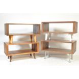 A collection of four modern minimalist low media units all having dark hard wood shelves raised on