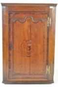 AN 18TH CENTURY GEORGE III OAK CORNER CUPBOARD