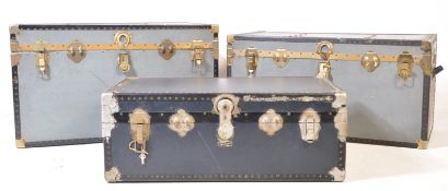 COLLECTION OF THREE GREY AND GILT METAL BOUND STEAMER TRUNKS