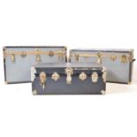 COLLECTION OF THREE GREY AND GILT METAL BOUND STEAMER TRUNKS