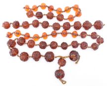 COLLECTION OF CHINESE CARVED AMBER FACE / HEAD BEADS