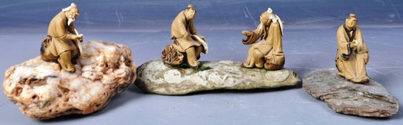 COLLECTION OF JAPANESE POTTERY FIGURES ON STONE BASES