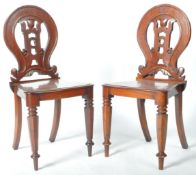 MATCHING PAIR OF VICTORIAN MAHOGANY CARVED HALL CHAIRS