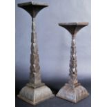 GRADUATING PAIR OF CAST IRON ECCLESIASTICAL CANDLE HOLDERS