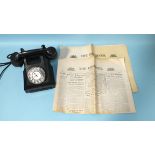 A Bakelite telephone, black, numbered BA D.62099 4849-1 and two Observer newspapers for 13th May