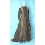 A late-Victorian c1880's brown silk dress, the front buttoned (37 buttons) from ruched neckline to