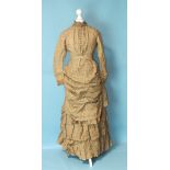 A Victorian machine-stitched day dress c1870's, of tan-coloured cotton, the high neck trimmed with