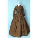 A Victorian brown silk hand-stitched two-piece day dress c1860, the boned bodice with front opening,