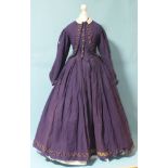 An early-Victorian three-piece dress, hand-stitched, of purple wool, the boned bodice with brass