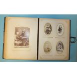 An album of seventy-three cartes de visite, including a cabinet card of a midget couple stood on a