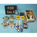 Four metal AA car badges, various plastic car badges and a vintage car number plate "For Sale" sign.