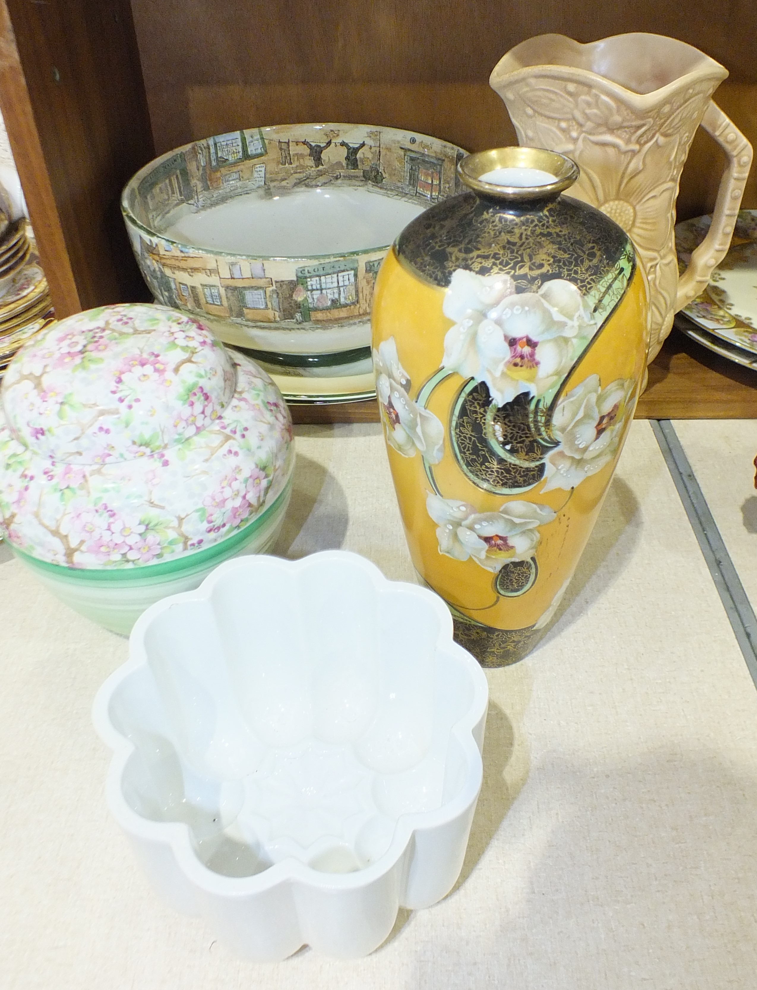 A Shelley Maytime decorated ginger jar and cover, 17cm high, a Shelley jelly mould, 9.5cm high, 15cm