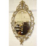 A modern gilt metal bevel-edged oval wall mirror with foliate surround, 127 x 70cm overall.