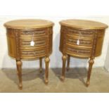 A pair of gilt-painted wood oval bedside tables in the French taste, each fitted with three