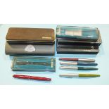 A collection of six various Parker fountain pens with five empty Parker pen cases.