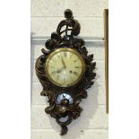 A 20th century stained wood cartel clock carved in the rococo style, the movement striking on a