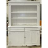 A Victorian white-painted pine dresser, the open shelves above two drawers and two cupboard doors,