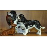 A Royal Doulton figure of a black and white cocker spaniel with pheasant, HN1137, 17cm high, a